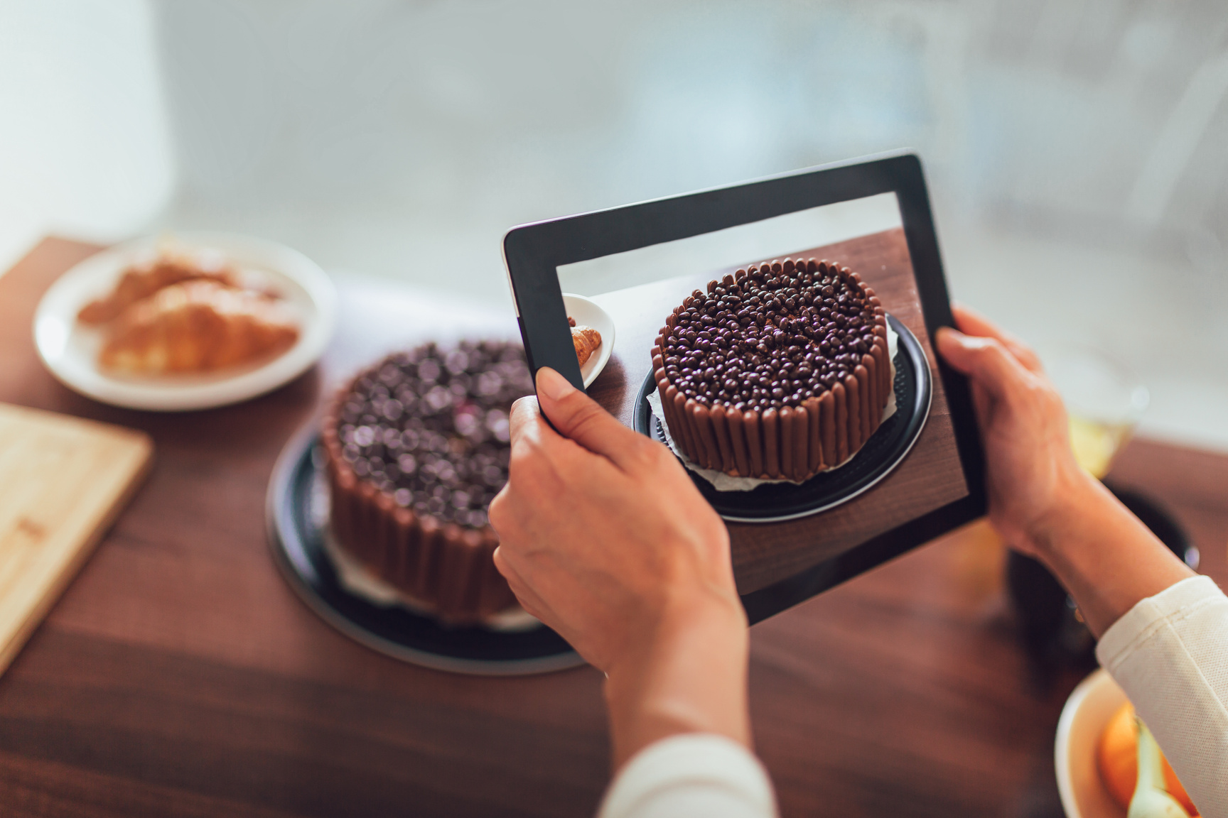 Blogger taking picture of cake to upload on website